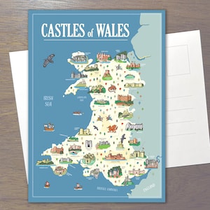 May include: A postcard featuring a map titled CASTLES OF WALES. The map displays the geography of Wales in cream against a blue background, illustrated with various castle icons, a red dragon, ships, and birds. The text labels identify locations.