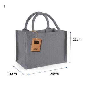 May include: A grey rectangular jute tote bag with two rounded handles and a brown paper tag attached by a string. The tag features the text Westford Mill and Jute. The bag measures 26 cm in length, 14 cm in width, and 22 cm in height.