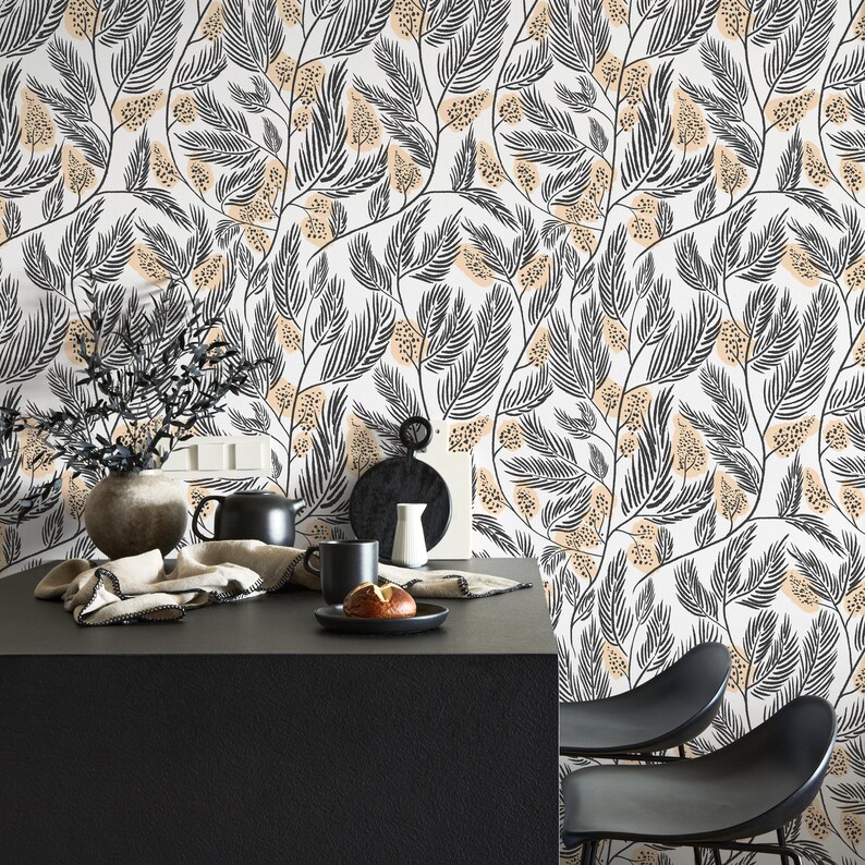 May include: A black and white floral wallpaper with a beige background. The wallpaper features a repeating pattern of stylized leaves and flowers. The wallpaper is shown in a kitchen setting with a black table and chairs.