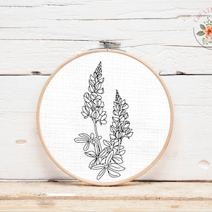 May include: Black and white line drawing of two lupine flowers in a hoop.