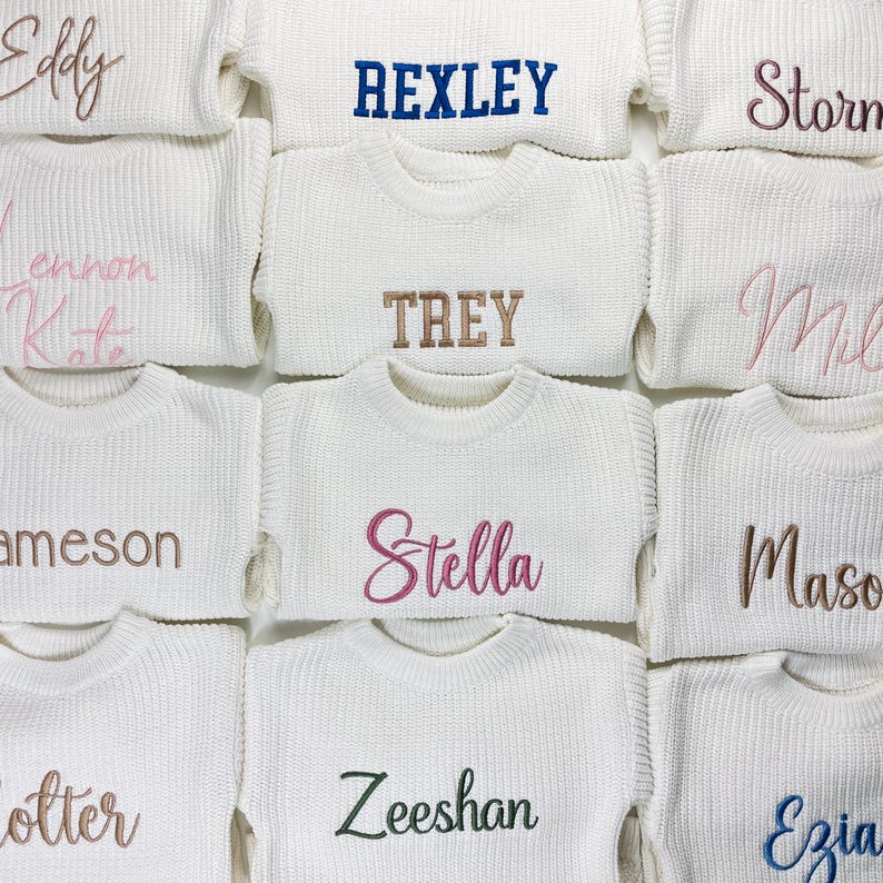 May include: A collection of white knit sweaters, each embroidered with a different name in various colors. The names include "Eddy", "Rexley", "Storm", "Lennon Kate", "Trey", "Mil", "Jameson", "Stella", "Mason", "Zeeshan", and "Ezia".