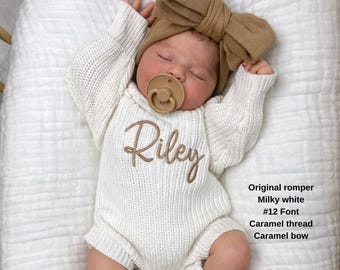 May include: A milky white knitted romper featuring the name Riley embroidered in caramel thread across the chest. The outfit includes a matching caramel-colored oversized fabric bow headband and a solid caramel pacifier. Text reads: Original romper, Milky white, #12 Font, Caramel thread, Caramel bow.