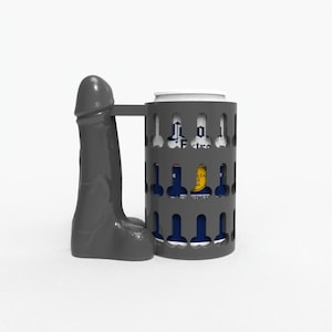 May include: A gray beer can holder with a handle shaped like a phallus. The holder has a cylindrical design with cut-out shapes. A beer can is visible inside the holder.