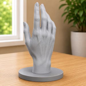 May include: A matte light gray hand-shaped display stand featuring a realistic anatomical design with visible knuckles, tendons, and fingernails. The hand is mounted vertically on a circular base of the same color, providing a stable structure.