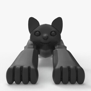 May include: A black, stylized cat figurine in a crawling pose. The cat has large paws, a small nose, and pointed ears. The figurine is made of a smooth, glossy material and is set against a white background.