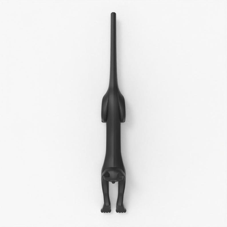 May include: A black cat-shaped bottle opener. The opener is depicted in a stylized, minimalist design, with the cat's body forming the handle and its head and paws at the base. The cat is shown in a stretching pose.