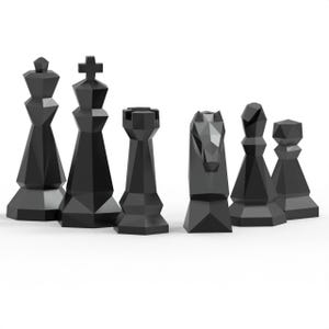 May include: A set of black chess pieces, including a king, queen, rook, knight, bishop, and pawn. The pieces have a geometric, faceted design and are arranged on a white surface. The king is approximately 4 inches tall.