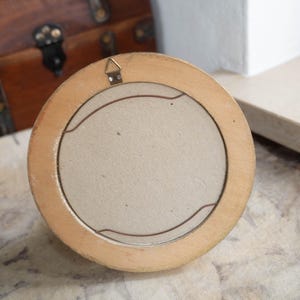 Back view of the vintage wood wall picture frame showing the hanging hardware and light backing board.