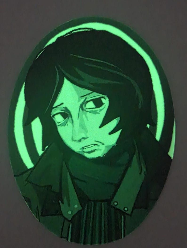 Puede incluir: Obra de arte ovalada que representa a una persona con cabello oscuro y una expresi&oacute;n sombr&iacute;a. La obra es principalmente verde, con un efecto brillante alrededor de la figura y un fondo oscuro. La persona lleva un abrigo oscuro.