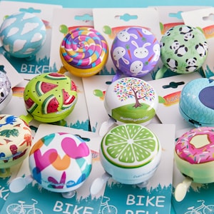 group of cute bike bells with packaging -cute bike accessories - bicycle accessory - gift for her - gift for bike rider - birthday gift - bicycle bell - Cute Things Seattle bike bell - holiday gifts, wheelchair accessories, cycling gifts