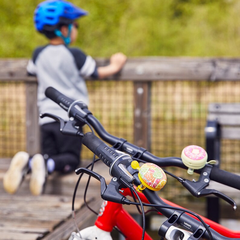 Cute bike bells on the handlebars

cute bike accessories - bicycle accessory - gift for her - gift for bike rider - birthday gift - bicycle bell - Cute Things Seattle bike bell - cycling gifts, holiday gifts, wheelchair accessories