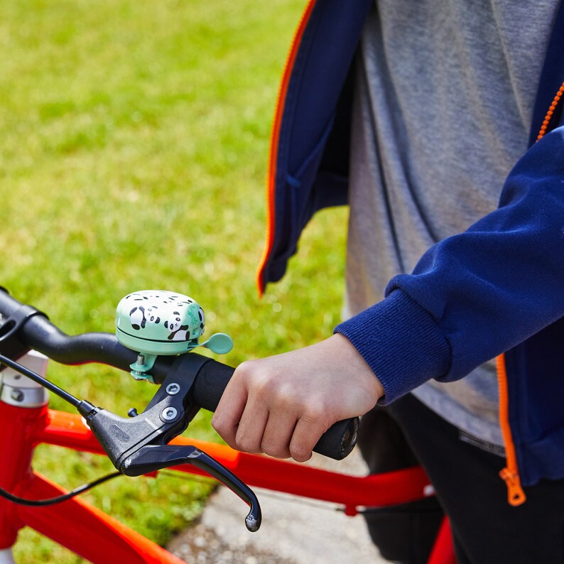 a cute panda bike bell on the handlebar

cute bike accessories - bicycle accessory - gift for her - gift for bike rider - birthday gift - bicycle bell - Cute Things Seattle bike bell - cycling gifts, holiday gifts, wheelchair accessories