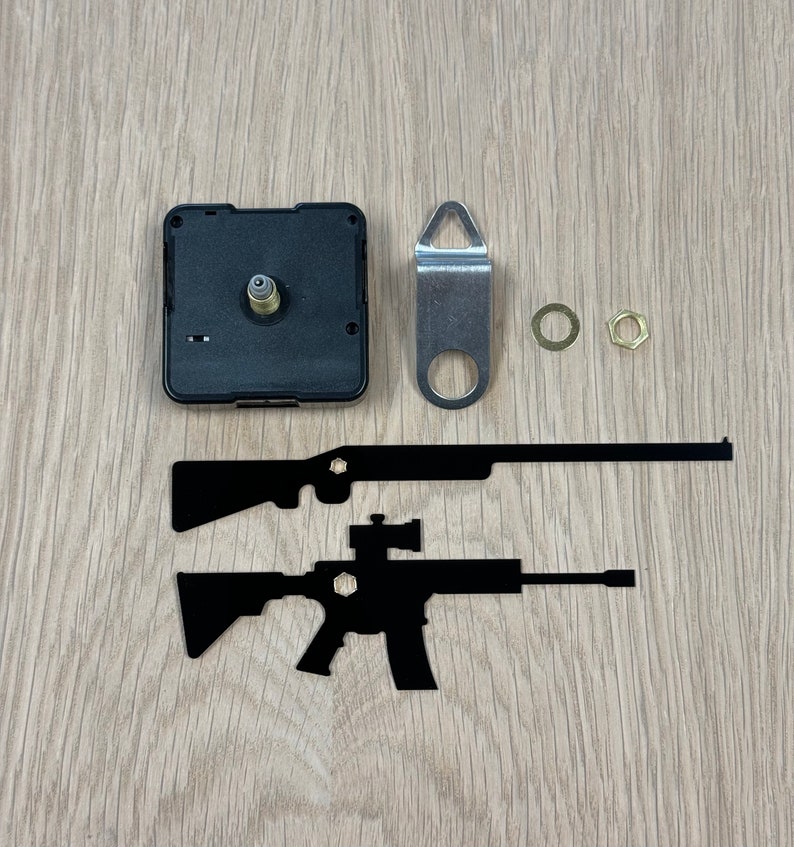 May include: Clock mechanism kit with black clock hands, a silver hanger, two gold-colored mounting hardware pieces, and two black silhouette cutouts of rifles.