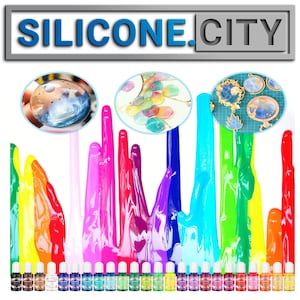 May include: A set of 16 colorful resin dyes in small bottles. The dyes are arranged in a rainbow pattern and are perfect for adding color to resin projects. The image also shows examples of resin projects that have been colored with the dyes, including a pendant, a keychain, and a small bowl.