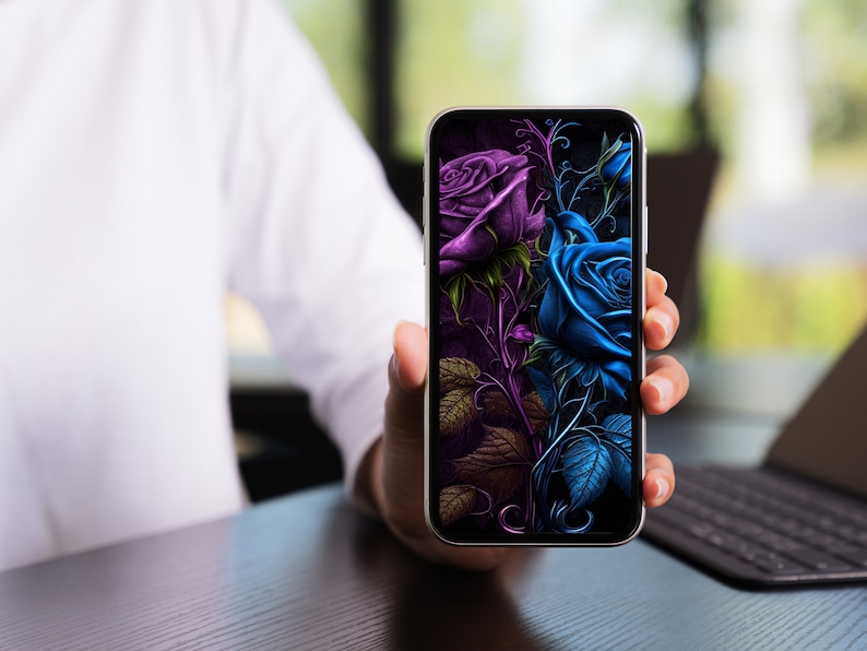 May include: A smartphone displaying a digital illustration of two roses, one purple and one blue, with intricate details and a dark background.