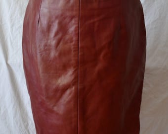 May include: A burgundy leather mini skirt with a straight cut and a simple design.