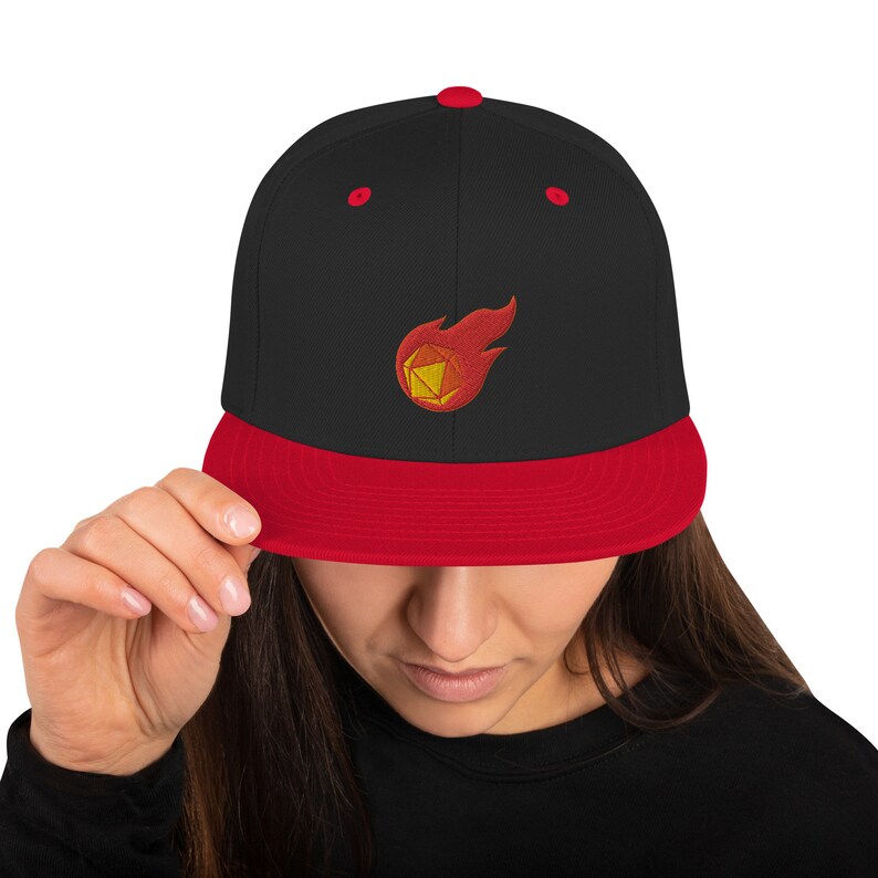 May include: A black and red baseball cap with a flaming dice embroidered on the front.