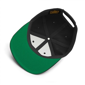 May include: Black and green baseball cap with a black mesh back and a green underside. The cap has a label that reads "Classics" in gold lettering.