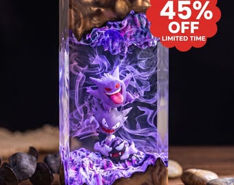 May include: A rectangular resin block featuring three stacked purple Gengar figures surrounded by swirling purple smoke effects. The top and bottom sections of the block are encased in a dark, marbled brown resin. A red circular badge displays 45% OFF.