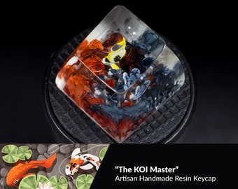 May include: A resin keycap with a koi fish design. The keycap is clear and shows a colorful koi fish swimming in a pond. The keycap is labeled "The KOI Master" and is described as an artisan handmade resin keycap. The keycap is 1U in size and has a SA profile. The stem type is Cherry MX switches. The production time is 1-3 days.
