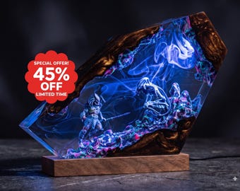 May include: A rectangular resin and wood lamp featuring a diorama of a Predator and an Alien figure. The clear resin contains swirling blue smoke effects and colorful textured terrain. A red circular badge displays SPECIAL OFFER 45% OFF LIMITED TIME.