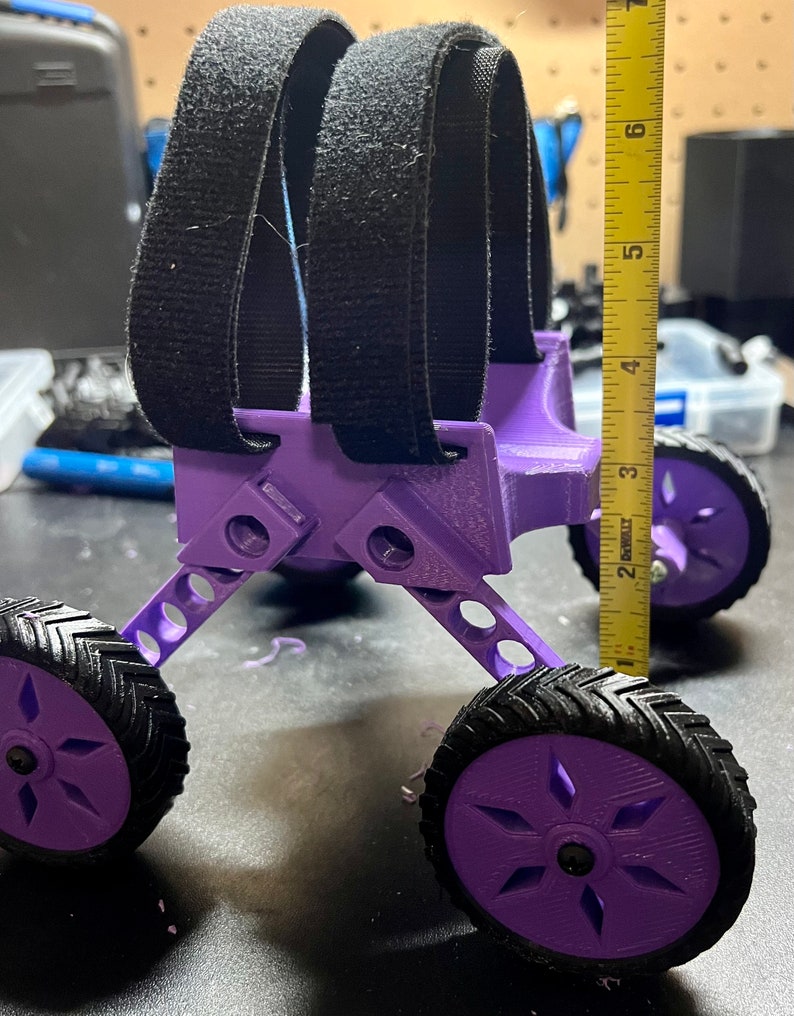 May include: Purple 3D printed toy car with black velcro straps, four wheels, and a measurement tape showing 6 inches in height.
