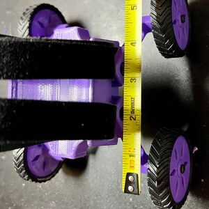 May include: Purple 3D printed toy car with black tires and a measuring tape showing the car is 4 inches tall.