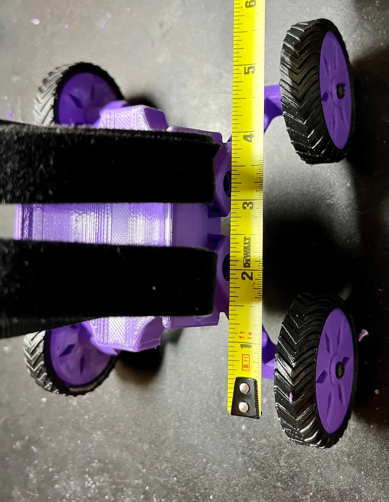 May include: Purple 3D printed toy car with black tires and a measuring tape showing the car is 4 inches tall.