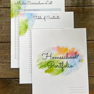 May include: A printable homeschool portfolio featuring a watercolour design in shades of blue, green, yellow, orange, and pink. The text "Homeschool Portfolio" is written in black cursive font. The portfolio includes a master curriculum list and a table of contents.