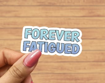 May include: A sticker with a blue and white gradient design that says "FOREVER FATIGUED" in a bold, white outline.
