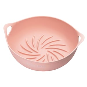 May include: A pink silicone steamer basket with a swirl design and the word "MOLIDE" printed on the bottom.
