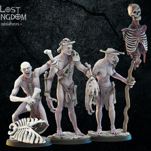 May include: Four skeletal figures with exposed bones and flesh, standing on circular bases. The figures are painted in shades of white and grey, with some areas of red. The figures are holding various bone weapons and tools. The figures are from the Lost Kingdom miniatures line.