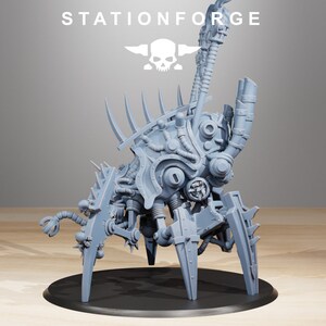 May include: A gray, detailed, multi-legged, mechanical creature with a large, round head and many pipes and gears. The creature is standing on a black circular base.