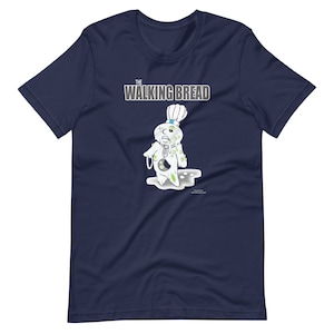 Puede incluir: Una camiseta azul marino con un gráfico blanco de un muñeco de masa de dibujos animados con moho verde y el texto "The Walking Bread".