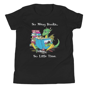 May include: A black youth t-shirt with a green dragon reading a book. The text on the shirt reads "So Many Books... So Little Time."