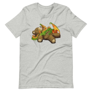May include: A brown teddy bear with a green dragon wrapped around it. The dragon has orange wings and a fire design around its body.