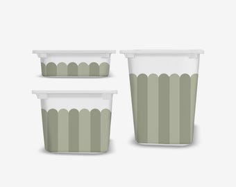 May include: Three white and green storage containers of different sizes. The containers feature a scalloped design in shades of green. The largest container is tall and cylindrical, the others are rectangular.