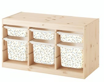 May include: A wooden storage unit with six white storage bins. The bins have a floral pattern with blue and black accents. The unit is made of natural wood.