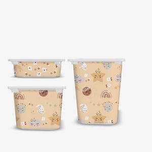 May include: Three plastic storage containers with different sizes. The containers have a white lid and a light beige body with a pattern of stars, moons, and rainbows.