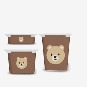May include: Three brown plastic storage bins with white lids. Each bin features a cartoon bear face with brown fur, a black nose, and pink cheeks.