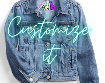 May include: A blue denim jacket with the text "Customize it" in neon blue lettering. The jacket has a colorful label with the text "lala" on the inside of the collar.