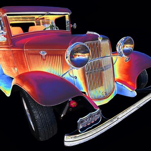 May include: A vintage red pickup truck with chrome accents and a black background. The truck has a grill with vertical bars and a large chrome bumper.