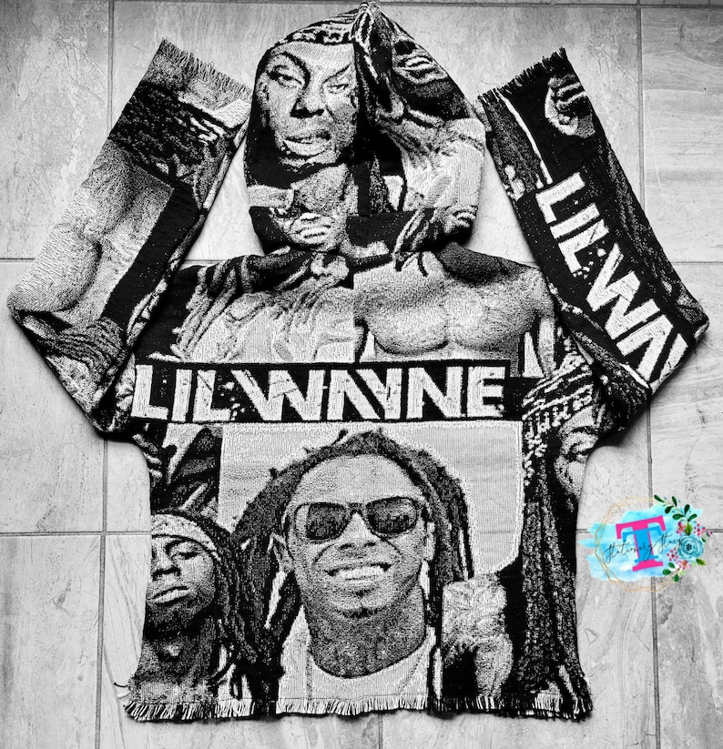 May include: Black and white hooded sweatshirt with a woven tapestry design featuring Lil Wayne's face and the text "Lil Wayne".