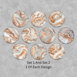 May include: Ten circular cabochons with a marble effect design. The cabochons have a mix of white, grey, and copper-coloured swirls. The text at the bottom reads "Set 1 And Set 2 1 Of Each Design."