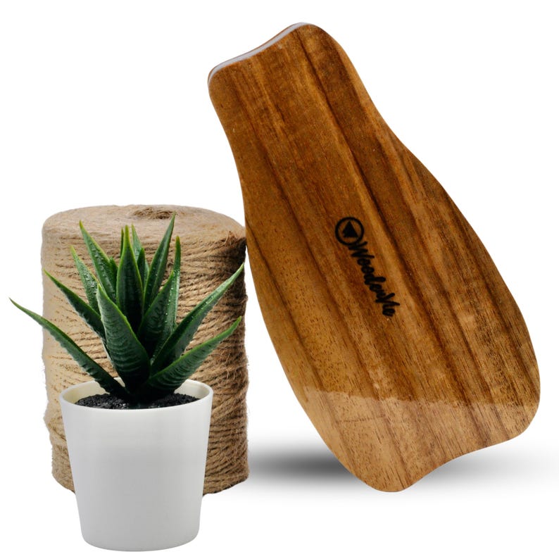 May include: A wooden paddle with a rounded shape and a smooth, polished surface. The paddle is made of light brown wood with darker brown streaks. The word "Woodcraft" is printed on the paddle in black lettering.