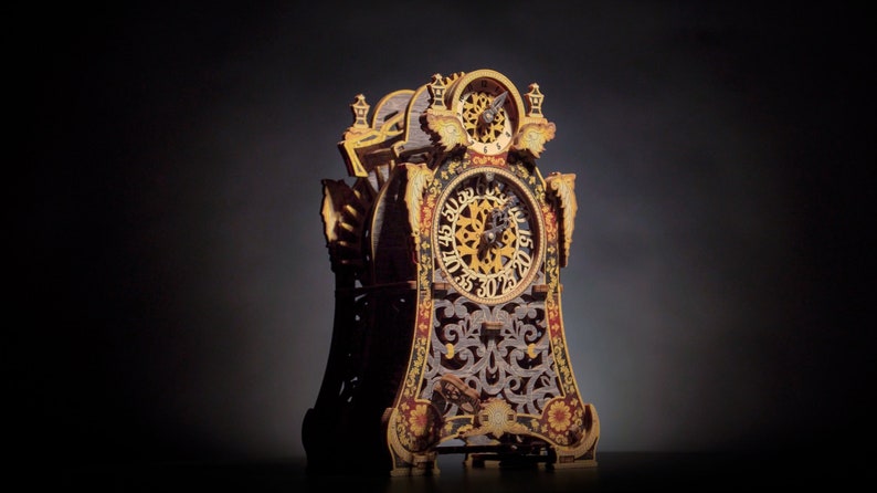 May include: A detailed, ornate wooden clock with gold accents and a black face. The clock has a decorative design with intricate carvings and a Roman numeral clock face.