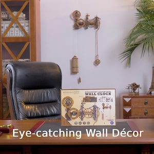May include: A steampunk-style wall clock kit and assembled clock are displayed. The kit box features gears and the text "Eye-catching Wall D&eacute;cor". The assembled clock is mounted on the wall, with hanging weights.