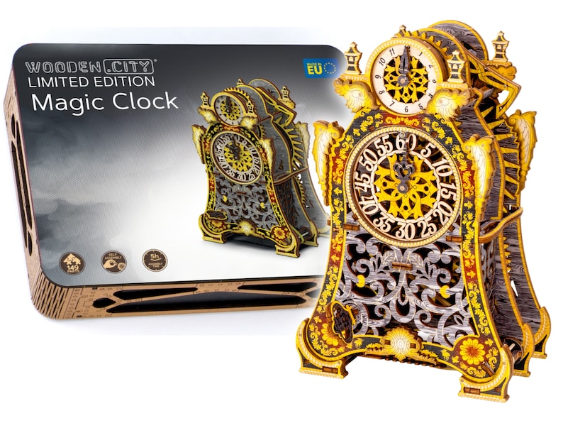 May include: A wooden 3D puzzle of a detailed, ornate clock with gold accents and a black face. The clock has a Roman numeral clock face and a separate minute hand clock face. The clock is on a white background. The box for the puzzle is visible in the background. The box is brown with the words "Wooden.City Limited Edition Magic Clock" printed on it.
