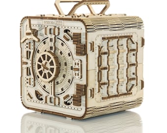 May include: A wooden model of a safe with a combination lock and a handle. The safe is made of light wood and has a natural finish. The safe is a 3D puzzle that can be assembled.