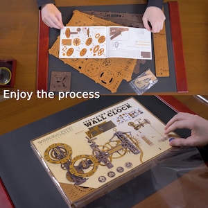 May include: A wooden steampunk gearworks wall clock kit with various laser-cut wooden pieces, gears, and instructions. The box is visible, along with the text "Enjoy the process."